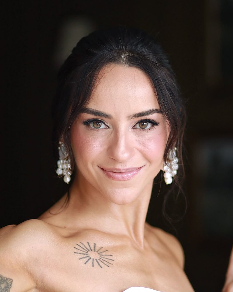 Noiva de cabelo preso com maquiagem suave e brincos de pérola